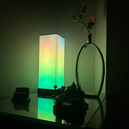 Compact FLOW Mini LED lamp with adjustable brightness and color options, perfect for small spaces and portable lighting needs.
