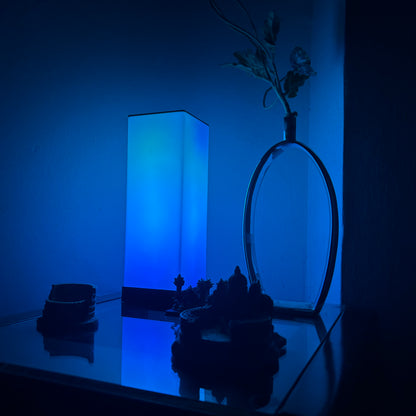 Compact FLOW Mini LED lamp with adjustable brightness and color options, perfect for small spaces and portable lighting needs.